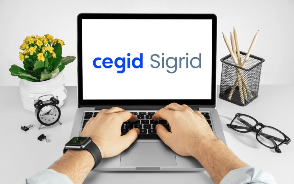 Vemos una imagen de una computadora con el logo de Sigrid ERP.